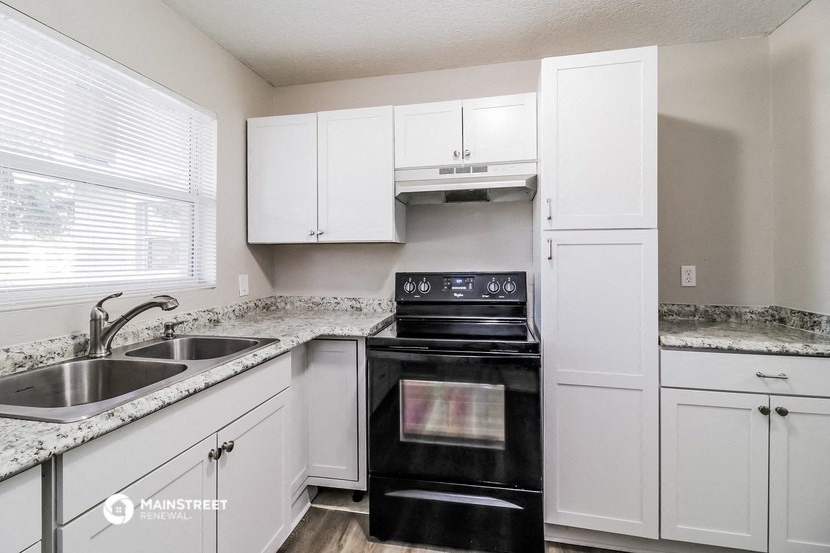 the preserve at ballantyne commons apartment kitchen with black appliances and white cabinets