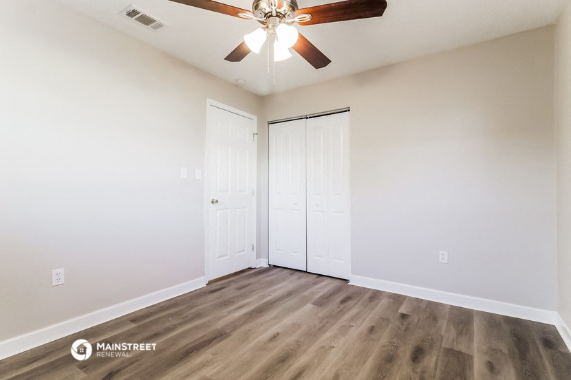 the living room of our studio apartment atrium with ceiling fan and closet