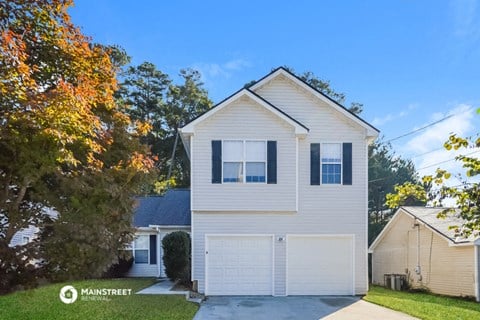 a white house with a white garage door