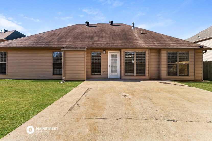 the front of a house with a driveway and a garage door