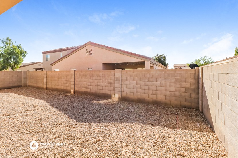 a retaining wall with a house in the background