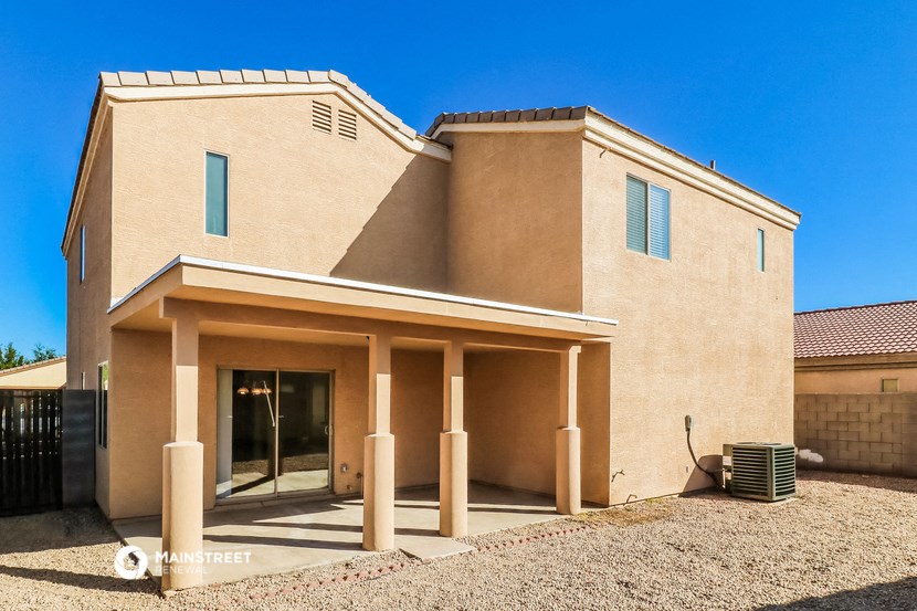 a new build house with a driveway and a gate