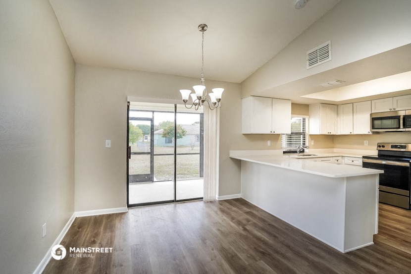 a kitchen with an island and a door to a patio