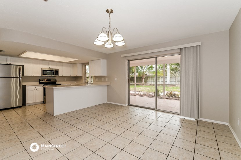 the kitchen and living room with sliding glass doors to the patio