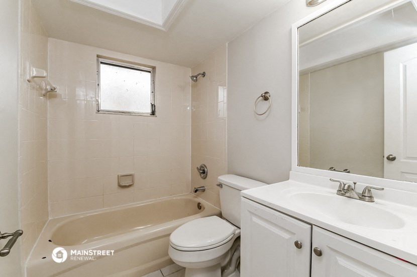a bathroom with a sink toilet and a bath tub