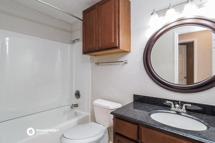 a bathroom with a sink and a toilet and a bath tub