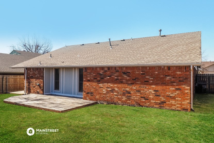 the front of a brick house with a porch