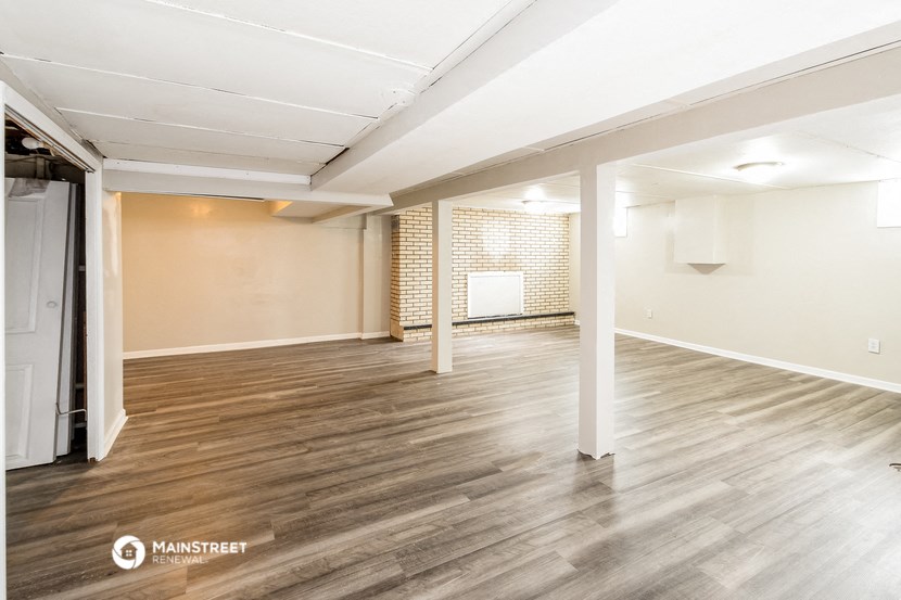 the living room and dining room of an apartment with wood flooring