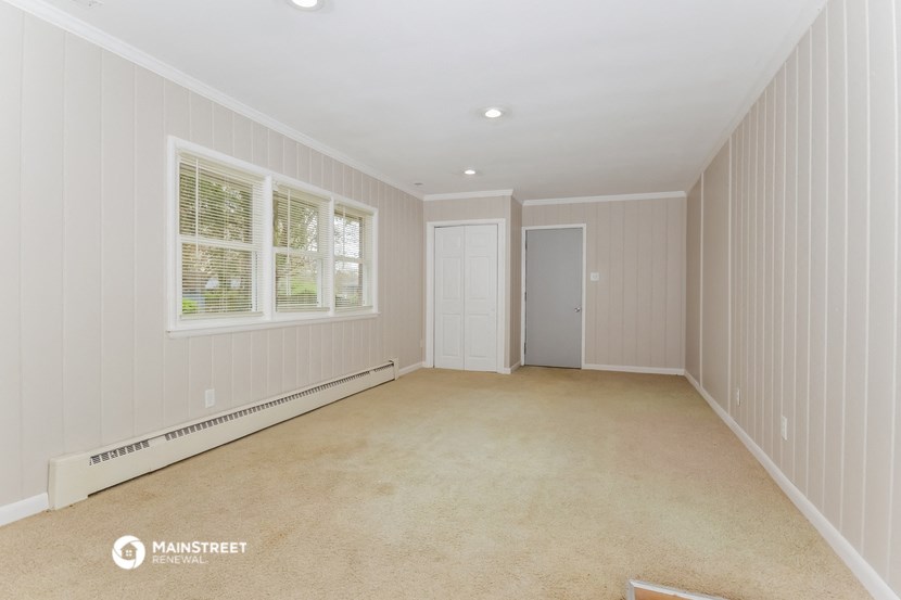 a empty room with a door and a window