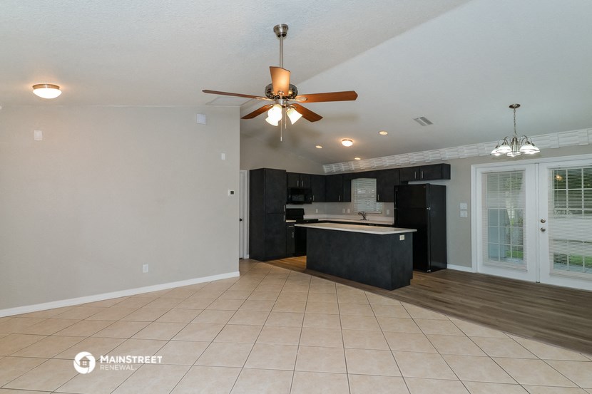 the kitchen is open to the living room and dining room
