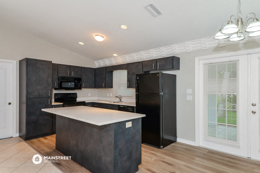 a kitchen with black appliances and a white counter top