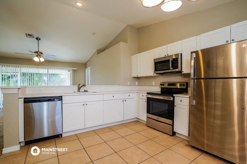 a kitchen with stainless steel appliances and white cabinets