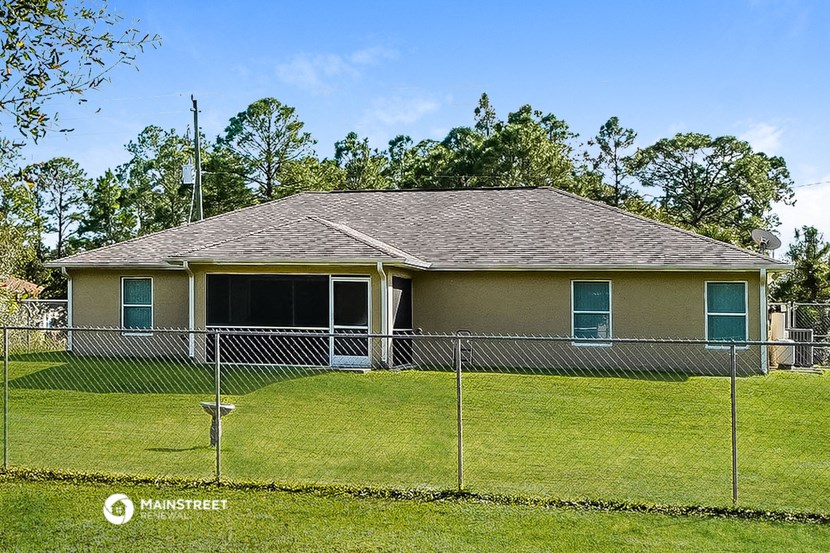 a house behind a chain link fence