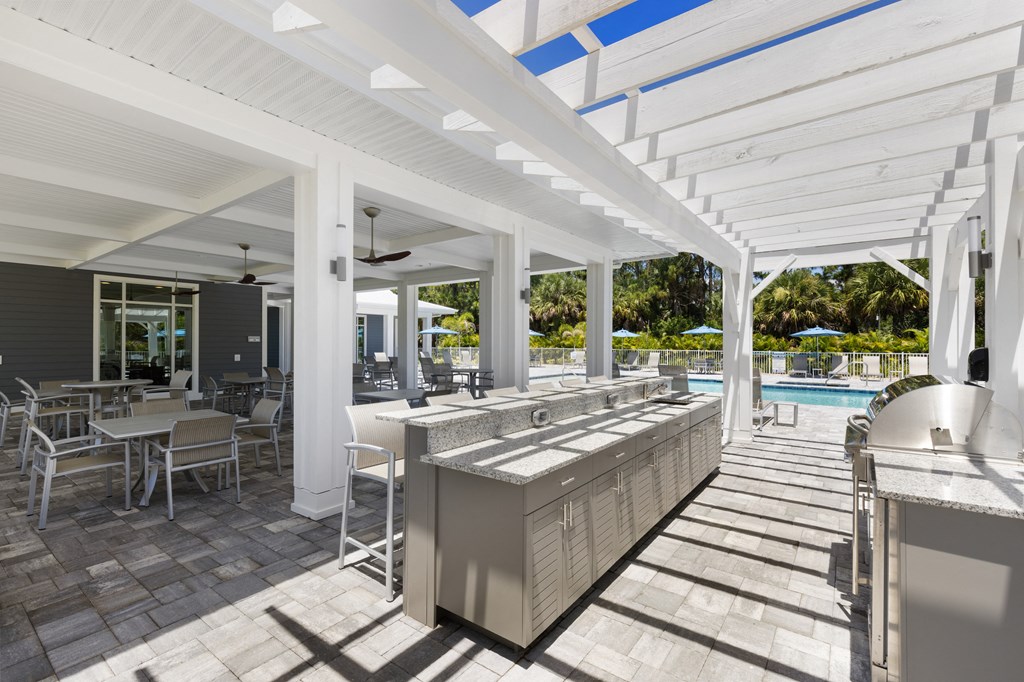 a resort bar with tables and chairs and a pool