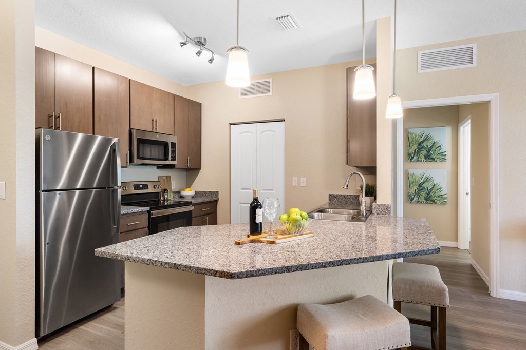 a kitchen with stainless steel appliances and a granite counter top