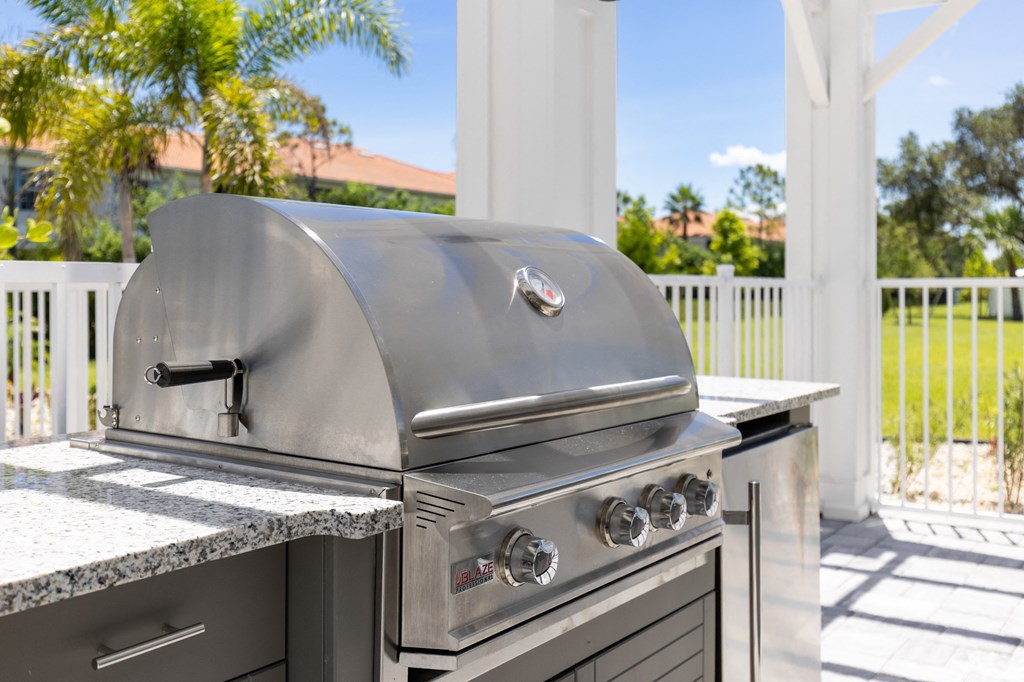 a stainless steel barbecue grill in an outdoor kitchen