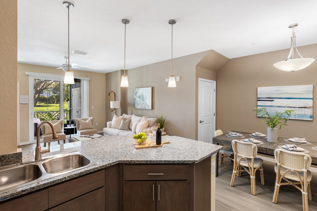 view of living room and dining room from the kitchen of an apartment