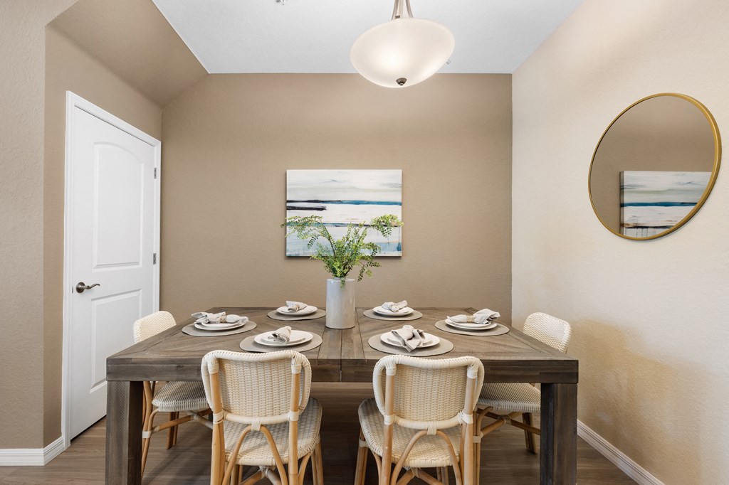 a dining room with a wooden table and chairs