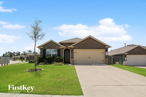 a house with a driveway and a lawn