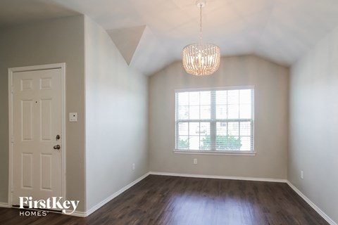 an empty room with a window and a white door