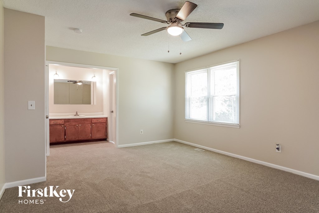the master bedroom is spacious and has a ceiling fan