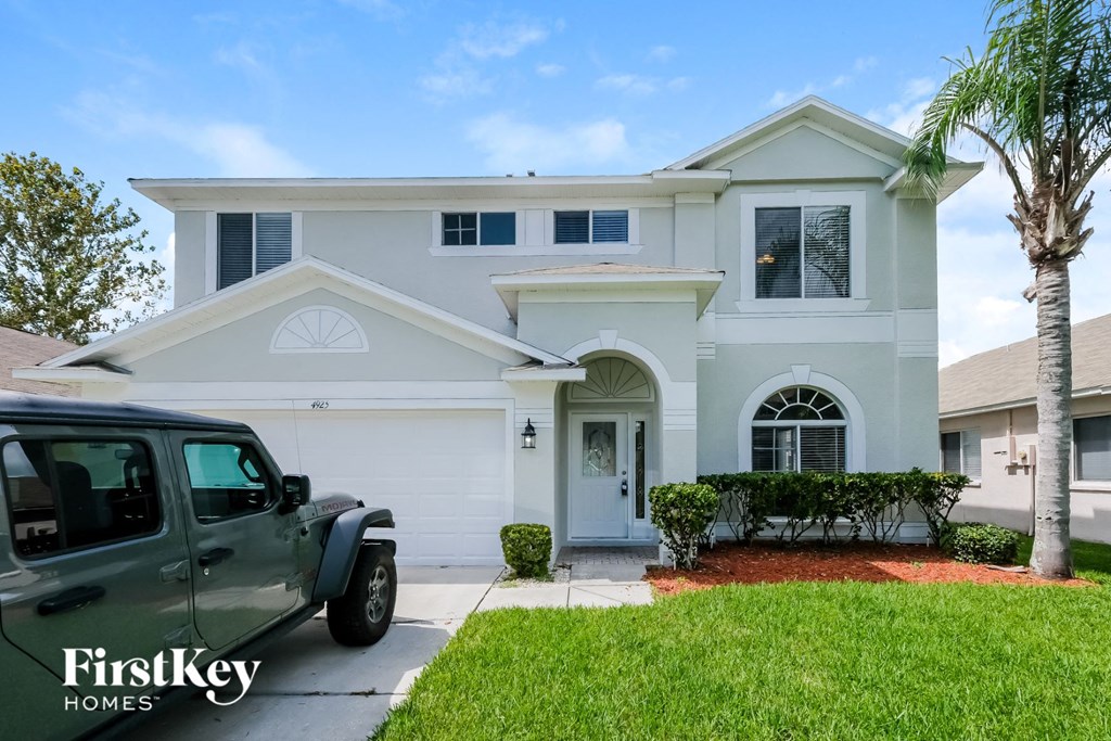 a white house with a truck parked in front of it