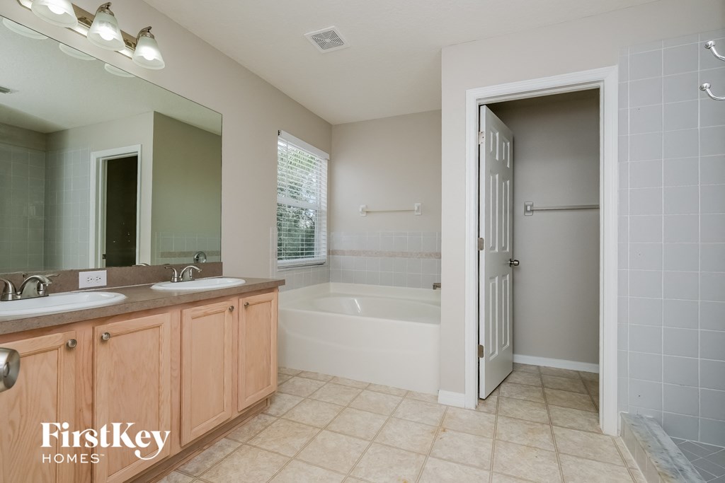 a bathroom with two sinks and a bath tub