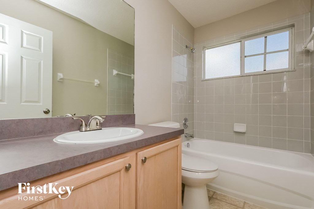 a bathroom with a sink and a toilet and a tub