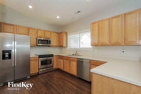 A kitchen with wooden cabinets and stainless steel appliances.