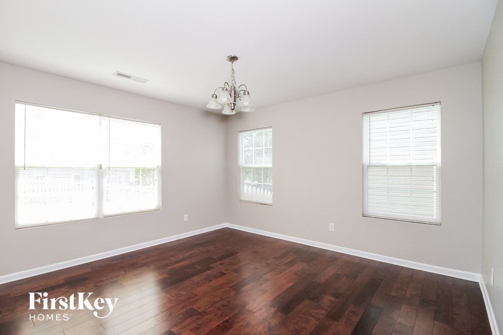 A room with wooden floors and a chandelier.