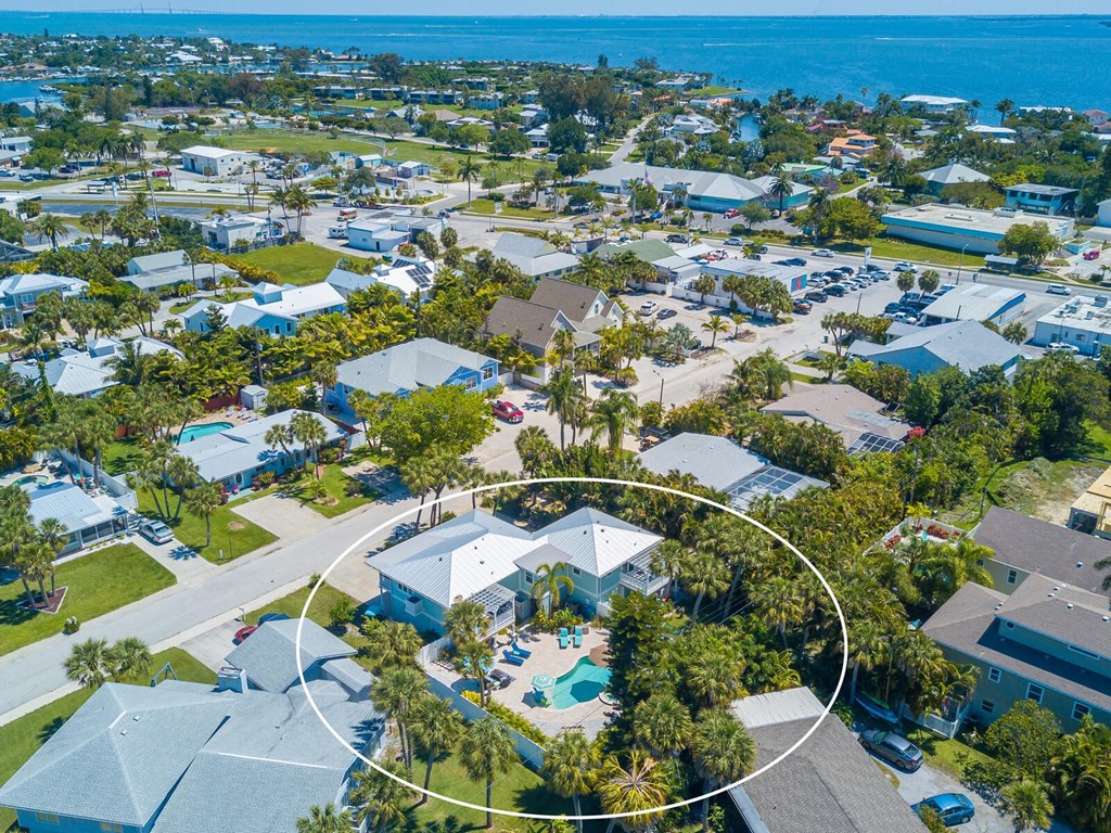 an aerial view of a neighborhood with a circled diagram of a house and a pool