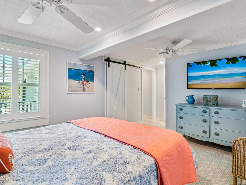 a bedroom with a bed and a ceiling fan
