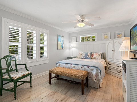 a bedroom with a bed and a ceiling fan