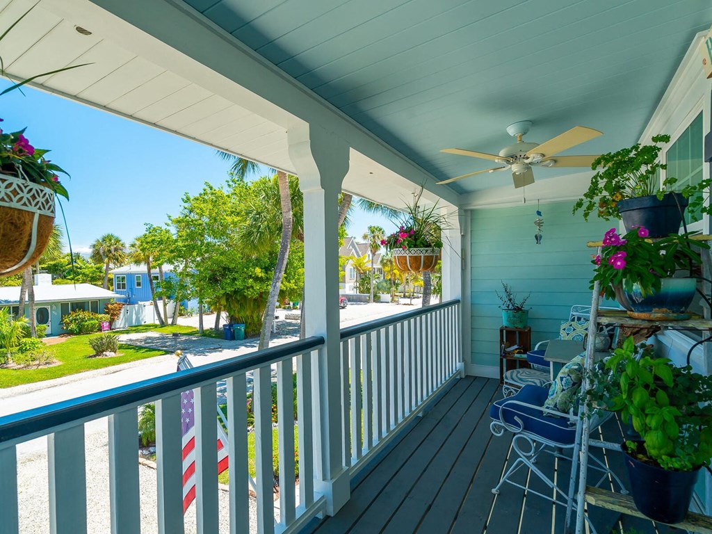 a view of the porch of a house with a fan