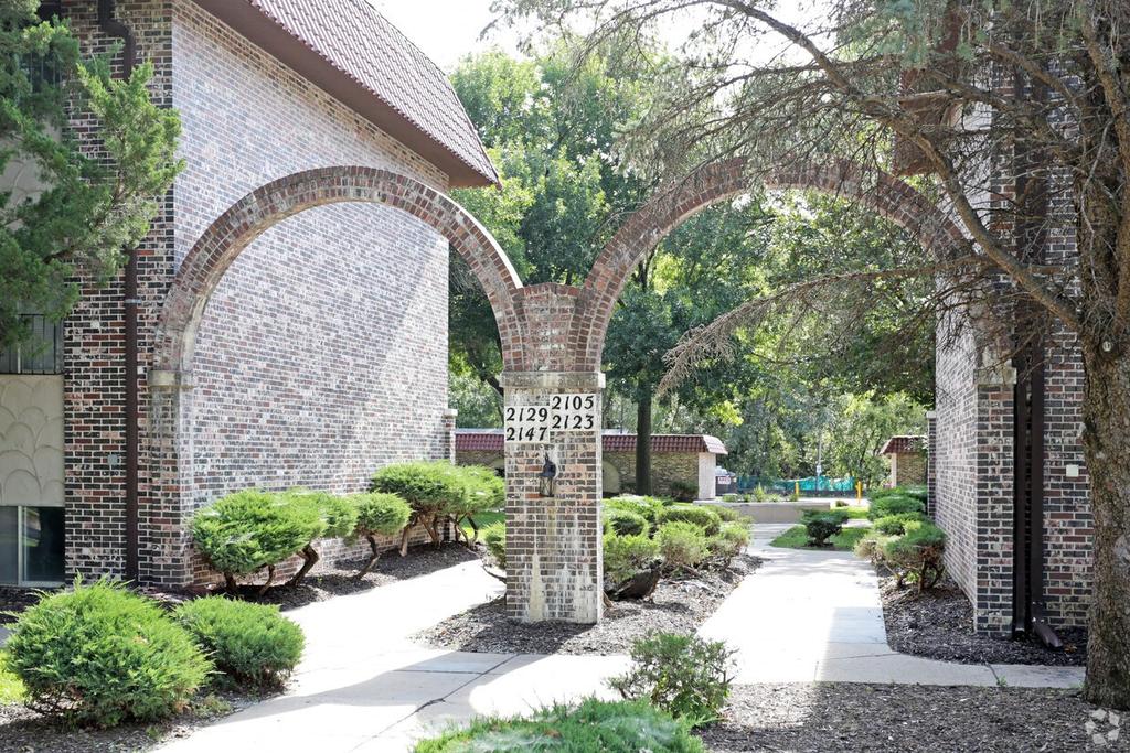 a brick archway with a sign in front of a building