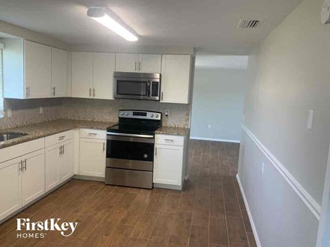A kitchen with a stove top oven and microwave.