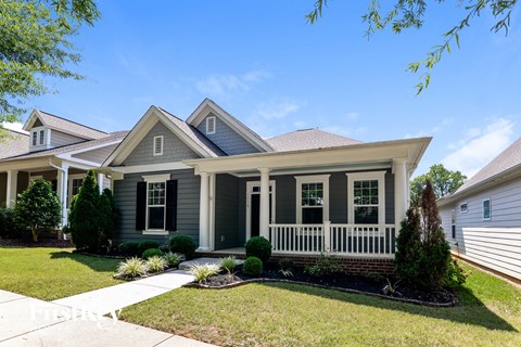 A house with a grey front and white trim.