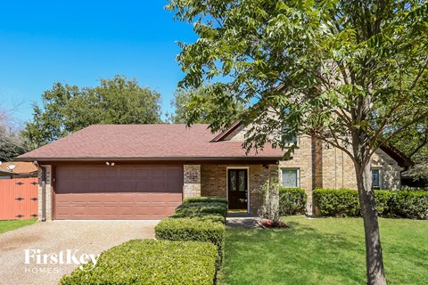 A house with a brown garage door is for sale.