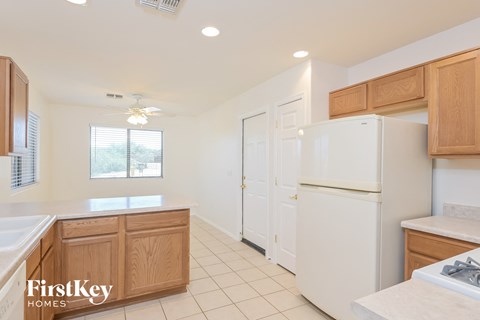 a kitchen with white appliances and wooden cabinets