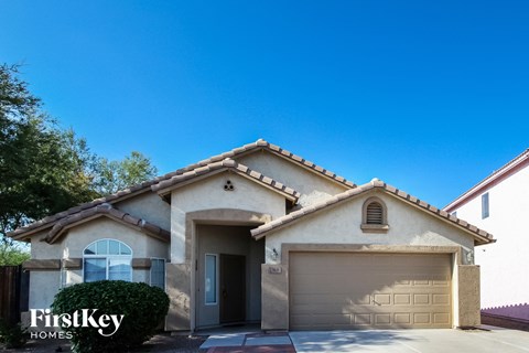 a house with a garage door in front of it