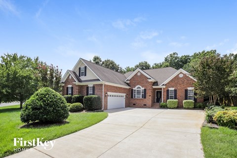 a brick house with a garage and a driveway