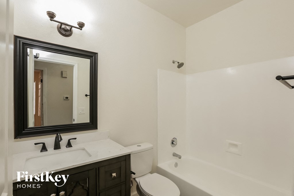 a bathroom with a toilet and a sink and a mirror
