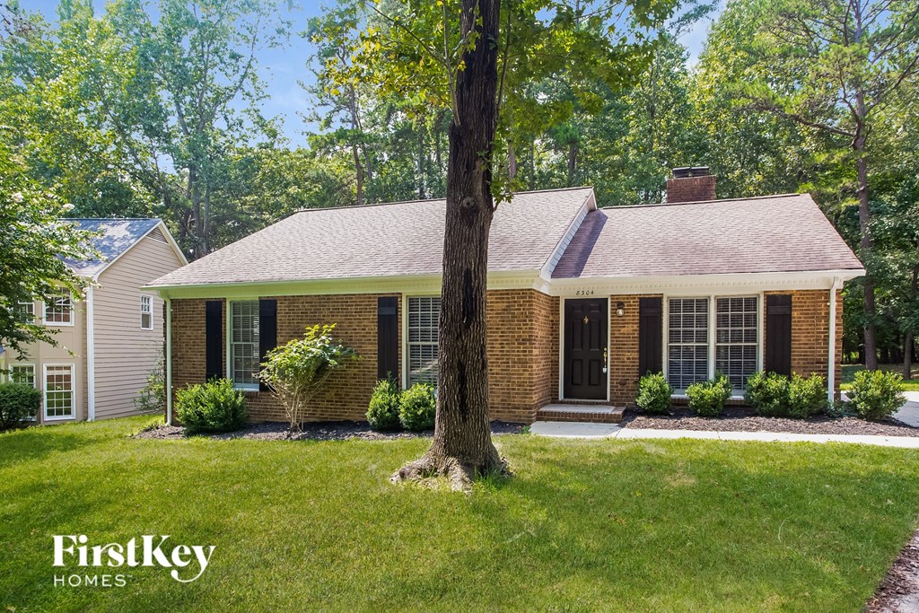 A house with a tree in front of it.