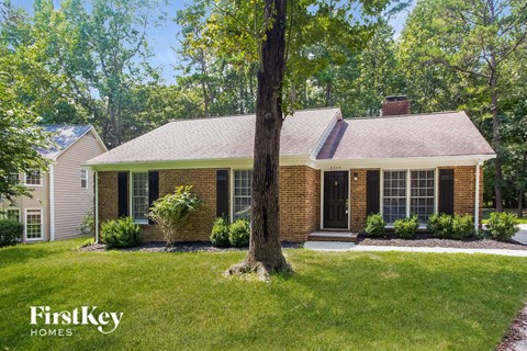 A house with a tree in front of it.