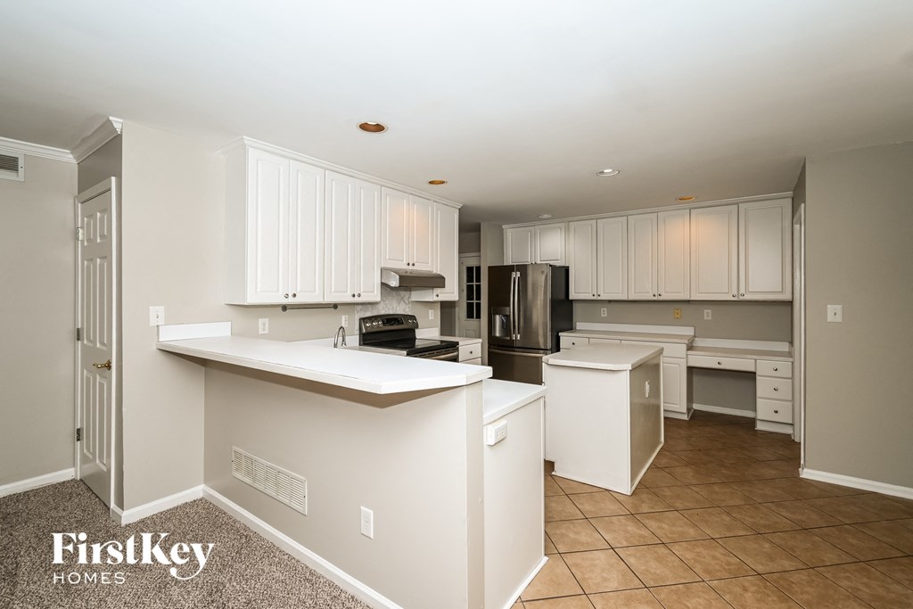 A kitchen with white cabinets and a countertop.