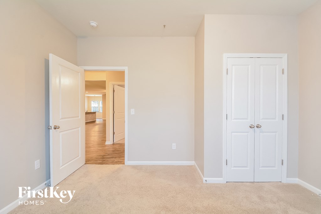 a bedroom with two closets and a door to a hallway
