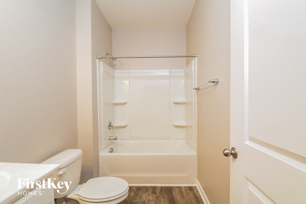 a bathroom with a shower and a toilet and a sink