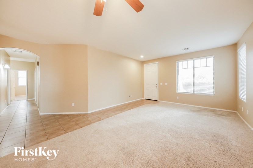 a empty living room with a door and a window