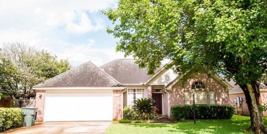 a brick house with a white garage door