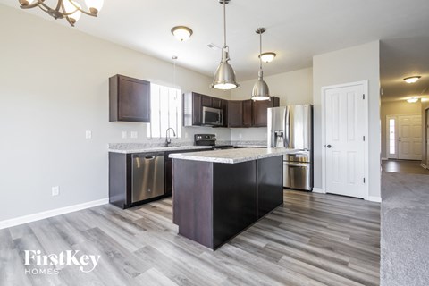 a kitchen with stainless steel appliances and a marble counter top